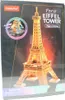 The image shows the packaging of a 3D puzzle of the Eiffel Tower, specifically the "Night Edition". Voir les images du produit