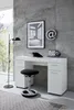 A modern white desk with a black stool and a floor lamp in a room with a concrete wall. Produktbild-Vorschau