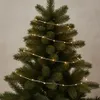 A close-up view of a Christmas tree decorated with string lights. Náhľad obrázku produktu