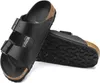 A pair of black Birkenstock Arizona sandals are shown on a white background. Produktbild-Vorschau