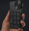 A hand holding a black digital drawing tablet accessory. Podgląd zdjęcia produktu
