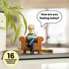 A small figurine of a psychologist sitting in a chair, with a speech bubble above it. Produktbild-Vorschau
