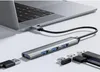 A USB hub is connected to a laptop, with other USB devices nearby. Náhled obrázku produktu