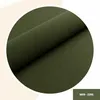 A close-up view of a roll of dark green fabric, presented within a circular frame. Anteprima dell’immagine prodotto