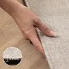 A hand is shown touching a textured fabric, possibly a rug or carpet, with a measurement indicator in the foreground. Produktbild-Vorschau