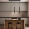 A modern kitchen with a central island and pendant lights. Produktbild-Vorschau