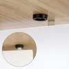 Close-up view of a furniture leg attachment on the underside of a wooden surface, with a magnified inset showing the detail. Voir les images du produit