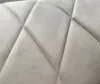 A close-up view of beige upholstered furniture with a diamond-stitched pattern. Náhľad obrázku produktu