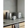 A modern kitchen counter with various kitchenware, including a toaster, canisters, and a mug. Anteprima dell’immagine prodotto