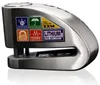 A close-up studio shot of a silver disc lock alarm for a motorcycle or bicycle, with various feature stickers on its side. Podgląd zdjęcia produktu