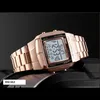 A rose gold digital watch is displayed on a dark surface. Náhled obrázku produktu