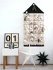 A Christmas advent calendar hanging on a wall, with decorative stars and a calendar block on a side table. Podgląd zdjęcia produktu