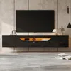 A modern living room with a wall-mounted TV cabinet and a large television. Podgląd zdjęcia produktu