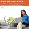 A woman is using a laptop while sitting on a couch in a living room with a heater in the foreground. Produktbild-Vorschau