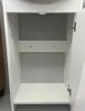 An empty white cabinet with an open door. Produktbild-Vorschau