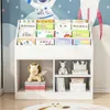 A white children's bookshelf filled with books and toys, set against a wall with a space-themed mural. Náhled obrázku produktu