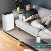 A man relaxing on a couch while listening to music, with an air conditioner running in the room. Anteprima dell’immagine prodotto