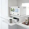 A white kitchen appliance with a drawer and a mug on a shelf. Podgląd zdjęcia produktu