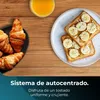 A breakfast scene with croissants and toast with peanut butter and bananas, set against a wooden background with a teal overlay at the bottom containing text. Voir les images du produit