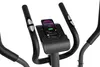 Close-up of the handlebars and console of an exercise bike, with a smartphone mounted on the console. Produktbild-Vorschau