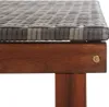 Close-up of the corner of a sun lounger, showing the woven grey poly rattan seat and the solid acacia wood frame. Náhľad obrázku produktu
