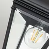 Close-up of a black outdoor pendant light fixture with glass panels and an Edison-style LED bulb. Produktbild-Vorschau
