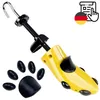 A yellow shoe stretcher with black accessories and a silver hook, placed on a white background. There are also black paw-shaped accessories in the lower left corner. Podgląd zdjęcia produktu