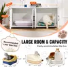 A white wooden cabinet designed to house cat litter boxes, with two compartments. One compartment contains a litter box, and the other has a cat bed with a cat. The top of the cabinet displays books and decorative items. The image also includes diagrams an Produktbild-Vorschau