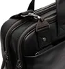 A close-up shot of a black leather bag, focusing on the zipper and a metal tag. Anteprima dell’immagine prodotto