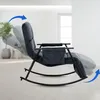 A dark gray rocking chair is shown in a reclined position, with blue arrows indicating movement. The chair is in a well-lit room with a plant in the background. Náhled obrázku produktu