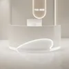 A modern, minimalist reception desk with a curved design and integrated lighting, set against a neutral background. Anteprima dell’immagine prodotto