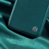 A close-up shot of a teal phone case with a silver logo on a teal satin fabric. Produktbild-Vorschau