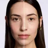 A split image showing a woman's face, with one side appearing to be before and the other after applying a product. Voir les images du produit