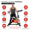 A man stands next to an indoor cycling bike, with various features of the bike highlighted with icons and text. Produktbild-Vorschau