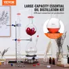 A laboratory setup for distilling essential oils, with various components and accessories arranged on a wooden surface. Produktbild-Vorschau