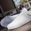 A close-up shot of a pair of white Adidas sneakers. Produktbild-Vorschau