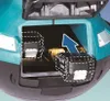 Close-up view of a battery compartment on a teal and black tool, with two batteries shown. An arrow indicates the insertion of one battery. Anteprima dell’immagine prodotto
