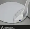 Close-up of the base of a modern LED desk lamp, showing a USB charging port and touch controls. Produktbild-Vorschau