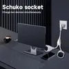 A desk setup with a monitor, a cup of coffee, a smartphone, and a power strip plugged into a wall socket. Voir les images du produit