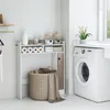 A laundry room scene with a washing machine and a bathroom storage unit. Voir les images du produit