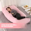 A pregnant woman is sleeping on a large pink U-shaped pillow in a bedroom. Anteprima dell’immagine prodotto
