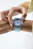 A person's wrist wearing a transparent blue G-Shock watch. Produktbild-Vorschau