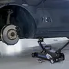 A car's wheel is removed and the car is supported by a hydraulic jack. Náhľad obrázku produktu