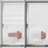 Two windows with roller blinds, one showing partial light blockage and the other showing near-complete light blockage. Podgląd zdjęcia produktu