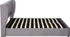 A side view of a gray upholstered bed frame with a slatted mattress support. Produktbild-Vorschau