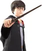 A child dressed as Harry Potter holds a wand. Produktbild-Vorschau
