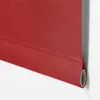 A close-up view of a red roller blind, showing the fabric texture and the bottom edge rolled around a tube. Produktbild-Vorschau