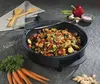 A black electric party pan filled with colorful stir-fried vegetables, placed on a dark gray textured surface. Surrounding the pan are fresh vegetables like carrots, ginger, a red bell pepper, mushrooms, and green beans, along with wooden serving utensils  Anteprima dell’immagine prodotto