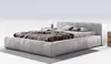 A modern upholstered bed with a headboard, two pillows, and a duvet, placed on a rug against a white background. Náhled obrázku produktu