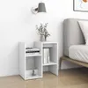 A white bedside table with books and decorative items next to a bed. Náhľad obrázku produktu
